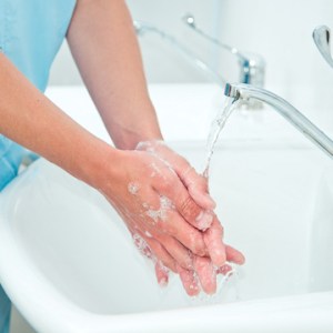 Dental assistant washing their hands