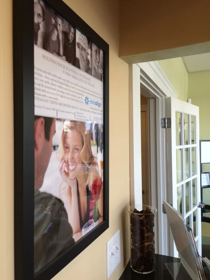 Framed Invisalign promo on the wall